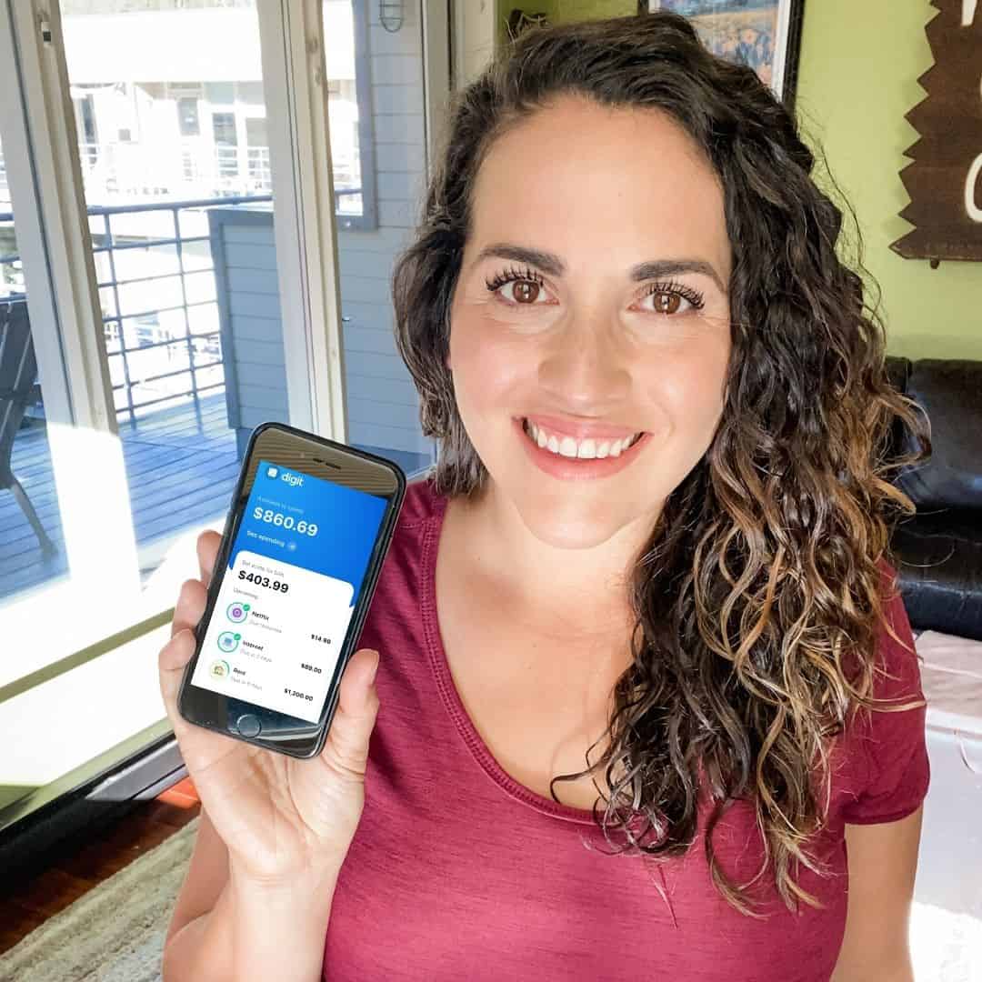 Woman holding phone with Digit Direct by MetaBank®