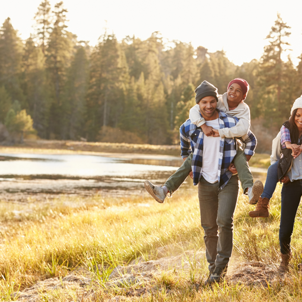 a family walking beside a creek